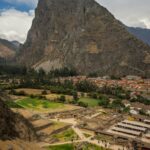 Breathtaking view of the ancient Inca ruins at Ollantaytambo with mountainous backdrop in Cusco, Peru.