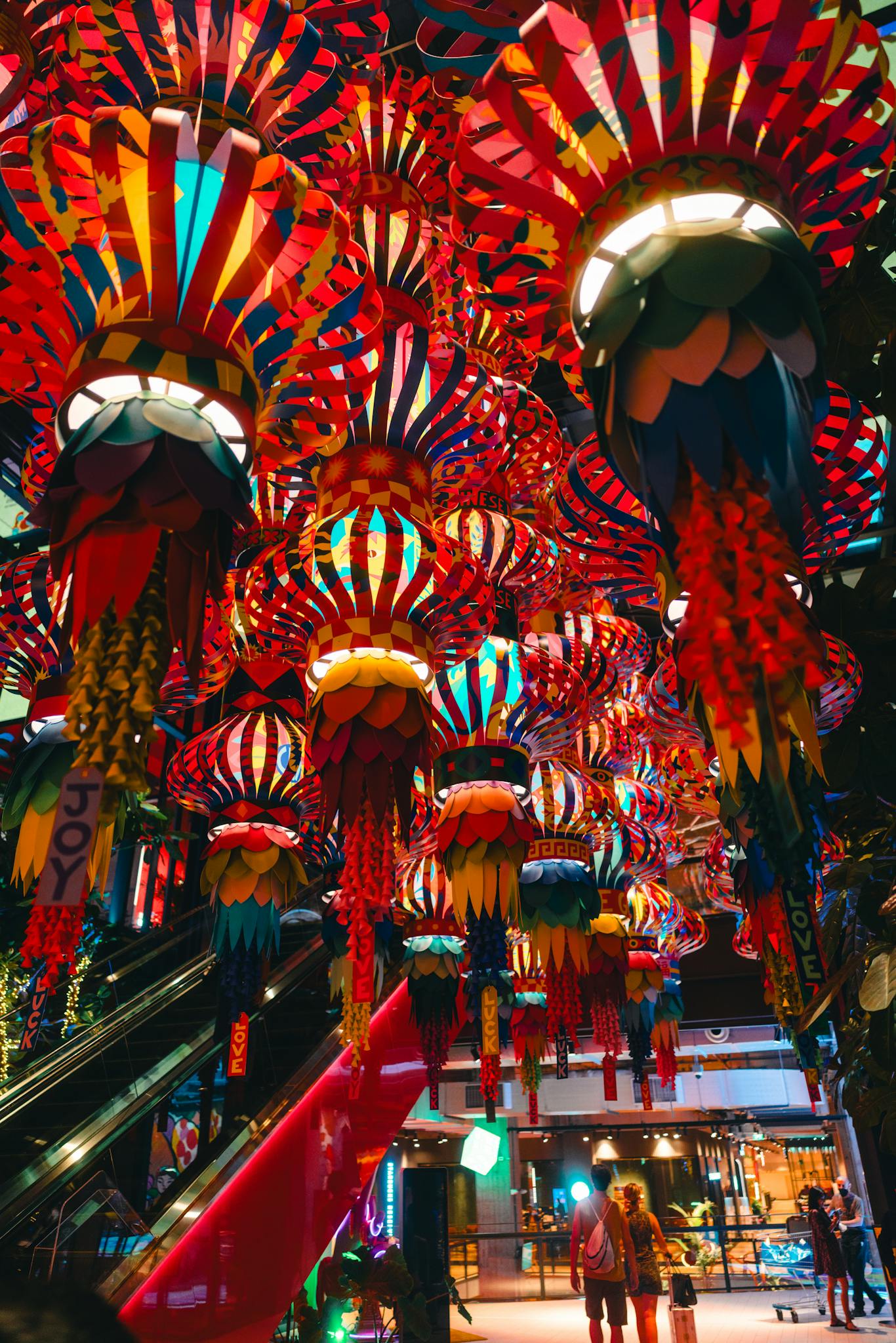 Colorful lanterns create a festive atmosphere in a Bangkok mall.
