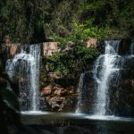 Stunning view of cascading waterfall amidst vibrant greenery in Thailand.