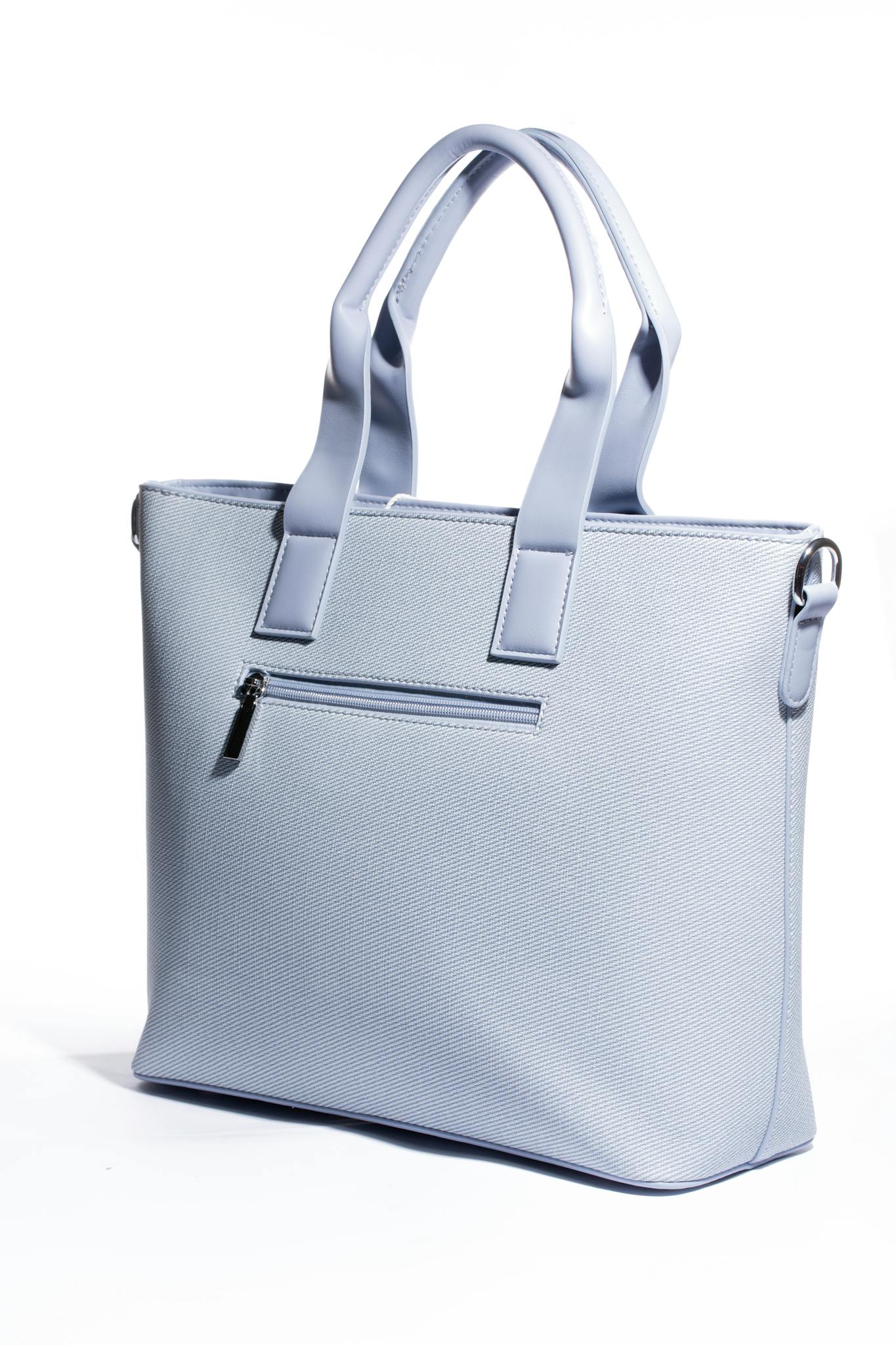 Stylish light blue handbag with textured surface and handles, perfect for fashion lovers.