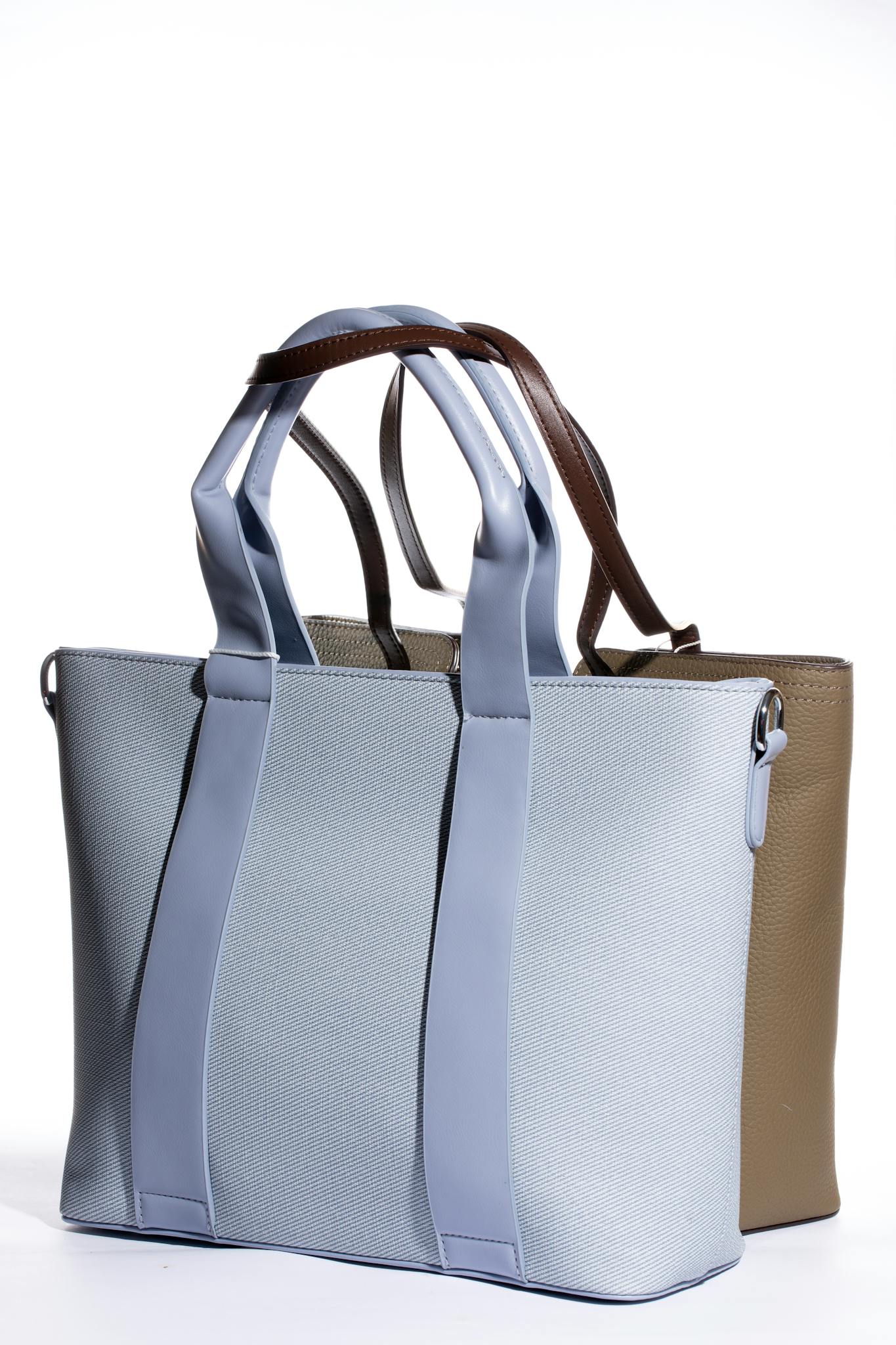 Two elegant tote bags in blue and tan displayed on a white backdrop showcasing modern style.